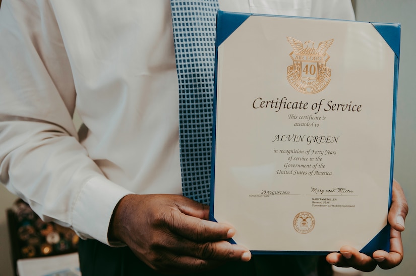 Alvin Green, director of cyberspace plans and resources for the 628th Communications
Squadron, holds his Certificate of Service at Joint Base Charleston, S.C., Sept. 9, 2020. Green
retires on December 31, 2020 after 40 years of civil and military service.