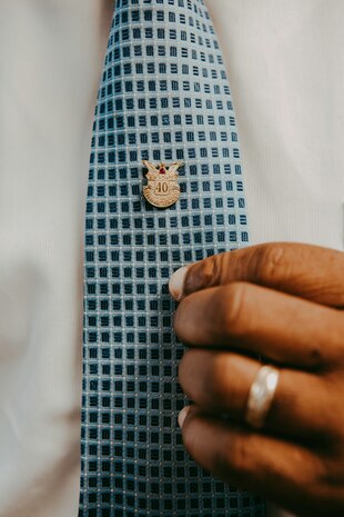 Alvin Green, director of cyberspace plans and resources for the 628th Communications
Squadron, displays his service pin at Joint Base Charleston, S.C., Sept. 9, 2020. Green retires on
December 31, 2020 after 40 years of civil and military service. (U.S. Air Force photo by SSgt
Lindsey Gulliver)
