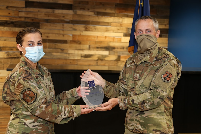 Staff Sgt. Kailey Mills, an HC-130 crew chief with the 176th Aircraft Maintenance Squadron, Alaska Air National Guard, accepts the regional-level Airman of the Year award from the Alaska National Guard’s Senior Enlisted Leader, Command Chief Master Sgt. Winfield Hinkley Jr. Sept. 2, 2020. Mills competed with Airmen from eight states in the northwest region to earn the award. In her civilian life, Mills is employed as a nurse and has introduced approximately 120 civilians to Air National Guard career paths, garnering three accessions. (U.S. Army National Guard photo by Sgt. Seth LaCount/Released)