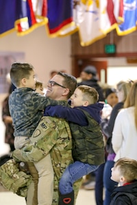 Alaska Army Guardsmen from the 297th Military Police Company visit with friends and family members following a deployment ceremony at the Alaska National Guard Armory on Joint Base Elmendorf-Richardson, Alaska, March. 13, 2019. Approximately 80 Alaska Guardsmen from the 297th Military Police Company are deploying to the U.S. Central command area of responsibility in support of Operations Spartan Shield for about nine months. (U.S. Army National Guard photo by 2nd Lt. Balinda O’Neal Dresel)