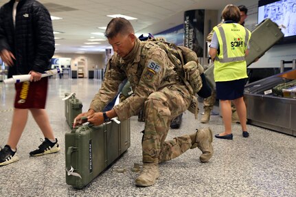 Master Sgt. Gary Keller, an Alaska Air Guardsman with the 176th Security Forces Squadron secures his luggage at Ted Stevens-Anchorage International Airport upon his return from Kandahar, Afghanistan on June 22, 2020. 12 AKNG Airmen deployed in support of Operation Freedom Sentinel, a NATO-led continuation of the Global War on Terrorism. (U.S. Air National Guard photo by Lt. Col. Candis Olmstead/Released)