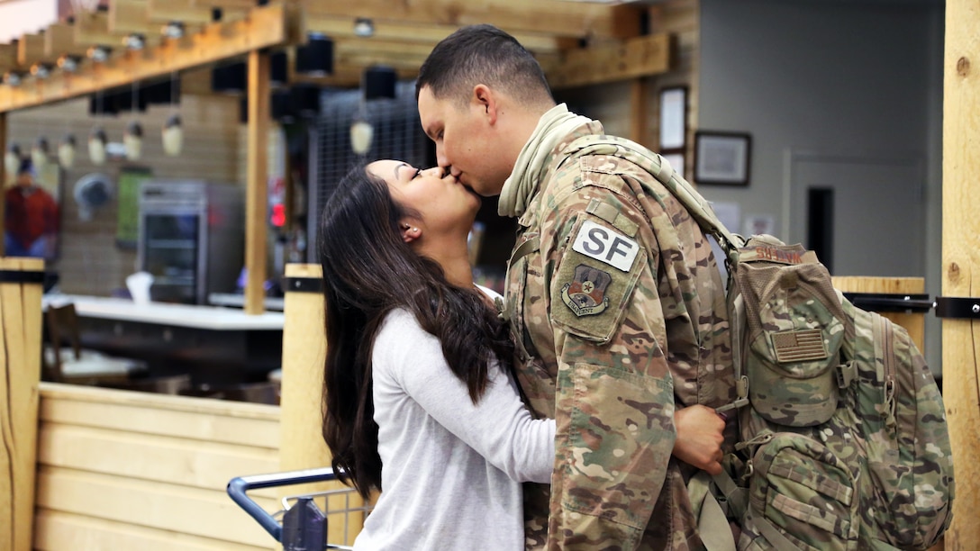 Airman 1st Class Kevin Waters an Alaska Air Guardsman with the 176th Security Forces Squadron shares a loving moment with his partner at Ted Stevens-Anchorage International Airport upon his return from Kandahar, Afghanistan on June 22, 2020. 12 AKNG Airmen deployed in support of Operation Freedom Sentinel, a NATO-led continuation of the Global War on Terrorism. (U.S. Air National Guard photo by Lt. Col. Candis Olmstead/Released)