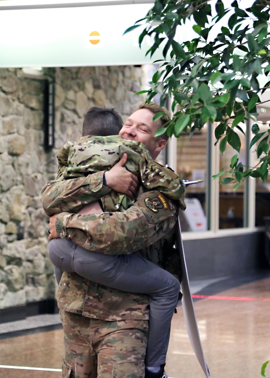 TSgt. Severin Stalmarck , an airman with the 176th Security Forces Squadron, embraces his son at Ted Stevens-Anchorage International Airport upon his return from Kandahar, Afghanistan on June 22, 2020. 12 AKNG Airmen deployed in support of Operation Freedom Sentinel, a NATO-led continuation of the Global War on Terrorism. (U.S. Air National Guard photo by Lt. Col. Candis Olmstead/Released)