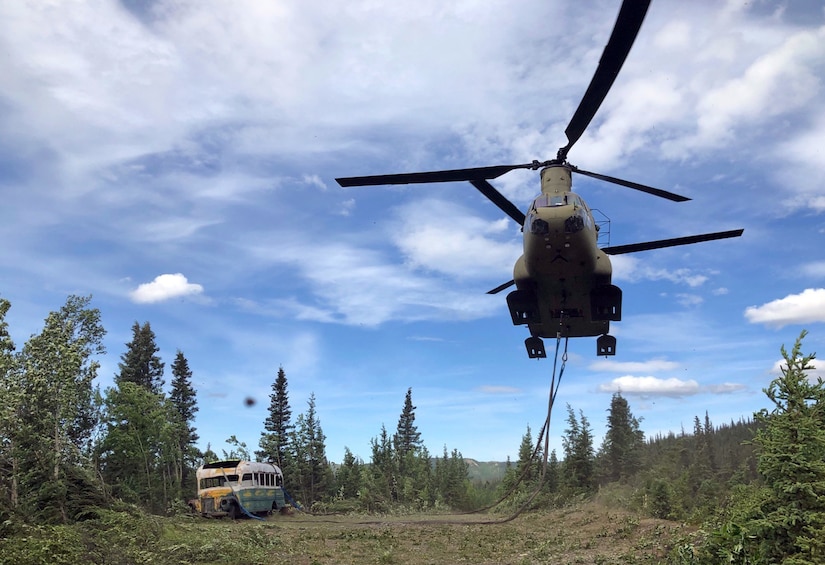 Alaska Army National Guard Soldiers assigned to 1st Battalion, 207th Aviation Regiment execute an extraction mission via a CH-47 Chinook helicopter over Healy, Alaska, June 18, 2020. As part of a combined effort with the Department of Natural Resources, the Guardsmen rigged and airlifted “Bus 142”,, an historic icon from book and film, “Into the Wild”, out of its location on Stampede Road in light of public safety concerns. The bus will be stored at a secure site while the DNR considers all options and alternatives for its permanent disposition. (Alaska National Guard courtesy photo)