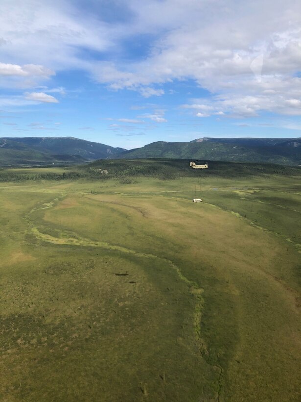 Alaska Army National Guard Soldiers assigned to 1st Battalion, 207th Aviation Regiment execute an extraction mission via a CH-47 Chinook helicopter over Healy, Alaska, June 18, 2020. As part of a combined effort with the Department of Natural Resources, the Guardsmen rigged and airlifted “Bus 142”,, an historic icon from book and film, “Into the Wild”, out of its location on Stampede Road in light of public safety concerns. The bus will be stored at a secure site while the DNR considers all options and alternatives for its permanent disposition. (Alaska National Guard courtesy photo)