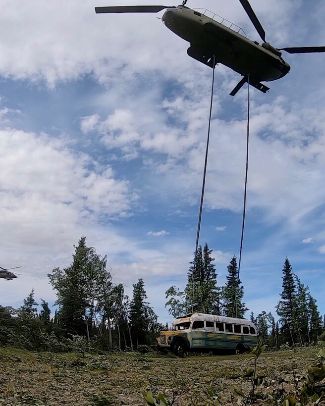 Alaska Army National Guard Soldiers assigned to 1st Battalion, 207th Aviation Regiment execute an extraction mission via a CH-47 Chinook helicopter over Healy, Alaska, June 18, 2020. As part of a combined effort with the Department of Natural Resources, the Guardsmen rigged and airlifted “Bus 142”,, an historic icon from book and film, “Into the Wild”, out of its location on Stampede Road in light of public safety concerns. The bus will be stored at a secure site while the DNR considers all options and alternatives for its permanent disposition. (Alaska National Guard courtesy photo)