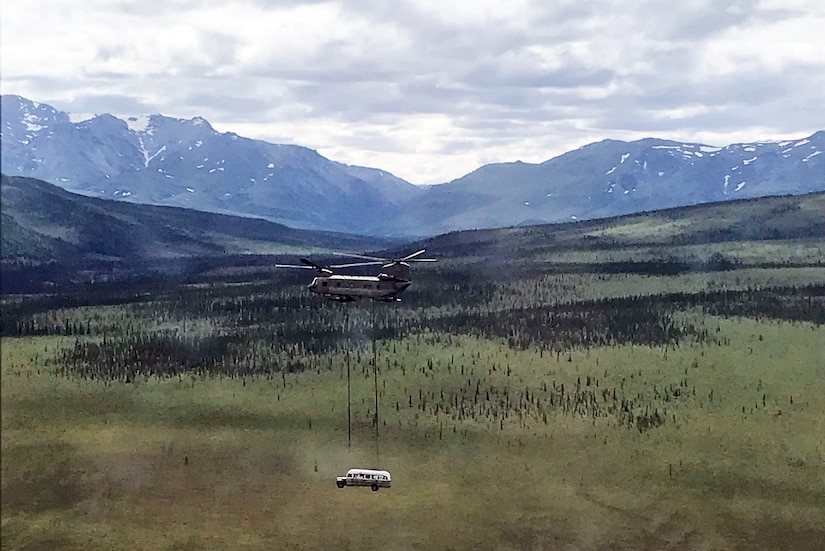 Alaska Army National Guard Soldiers assigned to 1st Battalion, 207th Aviation Regiment execute an extraction mission via a CH-47 Chinook helicopter over Healy, Alaska, June 18, 2020. As part of a combined effort with the Department of Natural Resources, the Guardsmen rigged and airlifted “Bus 142”,, an historic icon from book and film, “Into the Wild”, out of its location on Stampede Road in light of public safety concerns. The bus will be stored at a secure site while the DNR considers all options and alternatives for its permanent disposition. (Alaska National Guard courtesy photo)