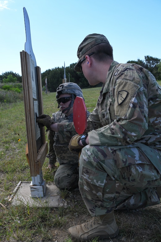 Alaska Army National Guard Specialist Sergeant Bridget Horton, 297th Regional Support Group works with Captain Thomas Howard during weapons zeroing at Fort Hood Texas, May 27, 2020. These two Soldiers had to qualify here in Texas due to scheduling conflicts in Alaska.(U.S. Army National Guard Photo by SGT Heidi Kroll)