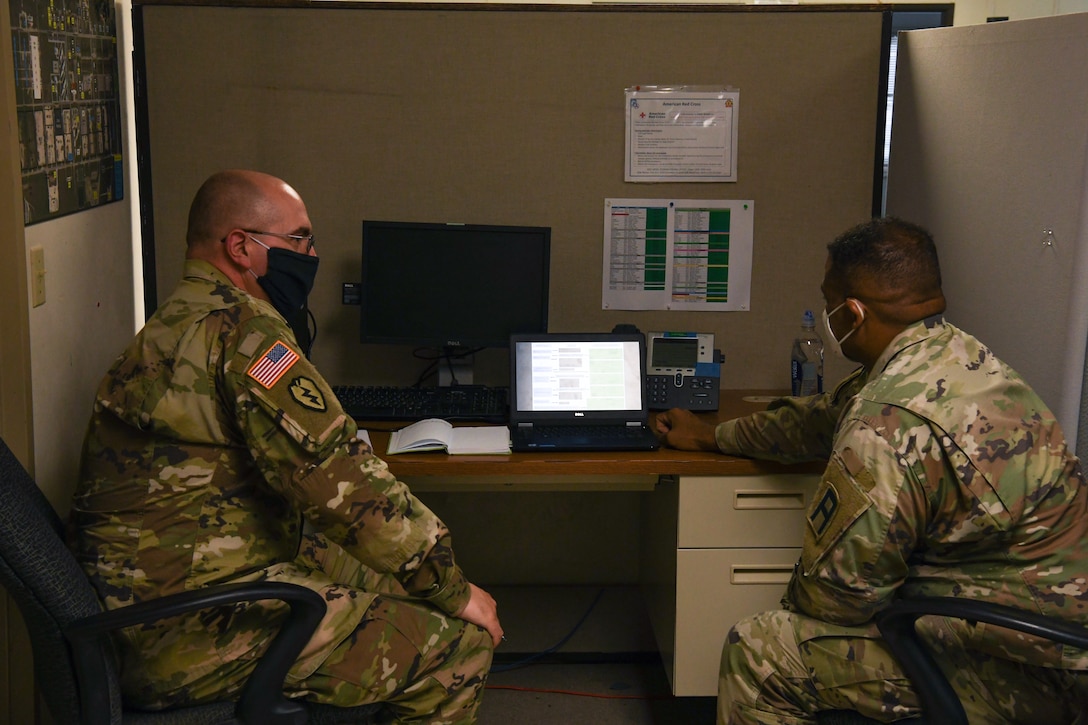 Alaska Army National Guard Sergeant Charles Medlin, 297th Regional Support Group, works with Sergeant 1st. Class Arthur Washington,120th Headquarters, Headquarters company Infantry Battalion, to go over his chaplain assistant duties while in Poland at Fort Hood, Texas, May 25, 2020. Chaplains Assistants are responsible for working with Soldiers in regards to their individual faiths, and making sure their religious needs are met. (U.S. Army National Guard Photo by SGT Heidi Kroll)