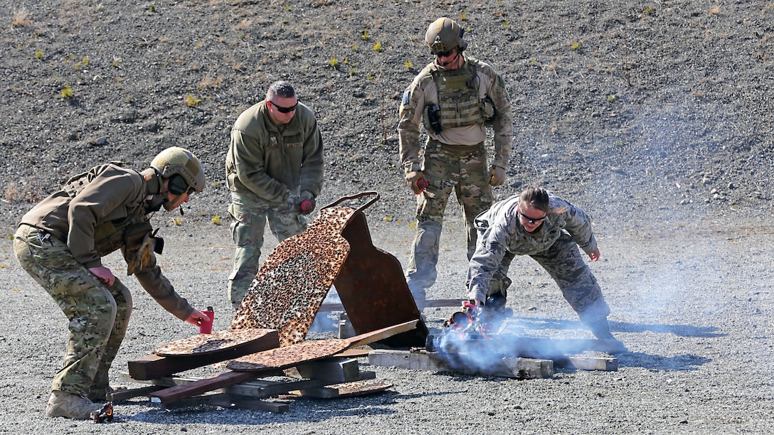 Alaska Air National Guardsmen assigned to the 212th Rescue Squadron place AN-M14 TH3 incendiary hand grenades atop steel silhouettes at the small arms complex on Joint Base Elmendorf-Richardson, Apr. 29, 2020. These grenades Use TH3, a form of thermite, which burns at very hot temperatures for 40 seconds, burning through half inch steel plate and fusing metallic parts. It produces its own oxygen and can even burn underwater (U.S. Army National Guard photo by Sgt. Seth LaCount/Released)