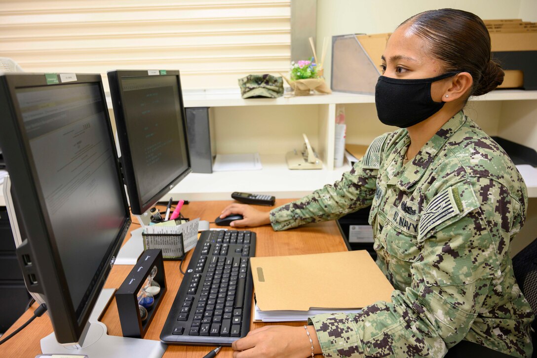 Woman works on computer.