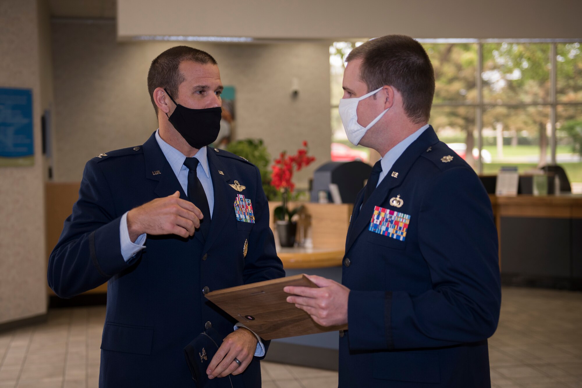 U.S. Air Force Col. Zachery Jiron, left, 60th Air Mobility Wing vice commander, speaks with Lt. Col. Andrew Wilkins, 60th Comptroller Squadron commander, during the 2019 Air Force Distinguished Credit Union Award presentation Sept. 9, 2020, at Travis Air Force Base, California. This marks the second year in a row that Travis Credit Union won this award. (U.S. Air Force photo by Senior Airman Cameron Otte)