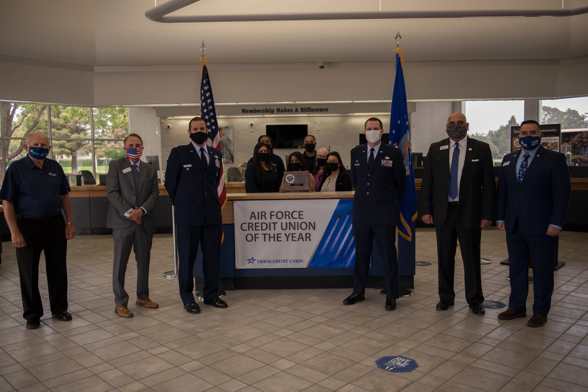 U.S. Air Force Col. Zachery Jiron, third from left, 60th Air Mobility Wing vice commander, Lt. Col. Andrew Wilkins, third from right, 60th Comptroller Squadron commander, and the Travis Credit Union staff stand around an Air Force Credit Union of the Year sign during the 2019 Air Force Distinguished Credit Union Award presentation Sept. 9, 2020, at Travis Air Force Base, California. Travis Credit Union earned the Air Force Distinguished Credit Union Award in recognition of the achievements they made over the course of a year. (U.S. Air Force photo by Senior Airman Cameron Otte)