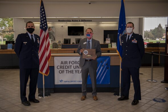 U.S. Air Force Col. Zachery Jiron, left, 60th Air Mobility Wing vice commander, and Lt. Col. Andrew Wilkins, right, 60th Comptroller Squadron commander, present Barry Nelson, Travis Credit Union president and chief executive officer, with the 2019 Air Force Distinguished Credit Union Award Sept. 9, 2020, at Travis Air Force Base, California. This marks the second year in a row that Travis Credit Union won this award. (U.S. Air Force photo by Senior Airman Cameron Otte)