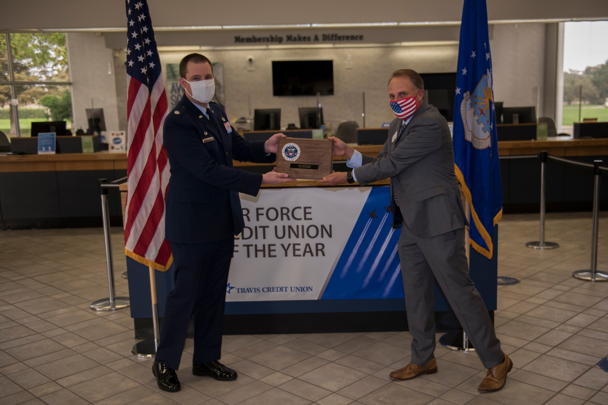 U.S. Air Force Lt. Col. Andrew Wilkins, left, 60th Comptroller Squadron commander, presents Barry Nelson, Travis Credit Union president and chief executive officer, with the 2019 Air Force Distinguished Credit Union Award Sept. 9, 2020, at Travis Air Force Base, California. This marks the second year in a row that Travis Credit Union won this award. (U.S. Air Force photo by Senior Airman Cameron Otte)