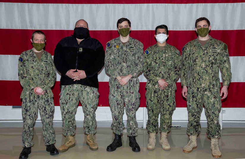Sailors on State Active Duty Orders for the Alaska Naval Militia pose for a group photo in the National Guard Armory at Joint Base Elmendorf-Richardson, April 14, 2020. (U.S. Navy photo by Mass Communication Specialist Victoria Granado/Released)
