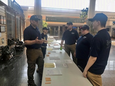 Members of the Alaska State Defense Force and Alaska Army National Guard Soldiers set up tables to screen incoming travelers before coming into Alaska at Ted Stevens Anchorage International Airport, Apr. 6, 2020. "It's great to work alongside the folks at the ASDF," said Pfc. Connor Sheehan, an AKARNG signal specialist. "The prior service connection has definitely made for a positive experience for me, and it's great to be out here helping people who need it." (Courtesy photo)