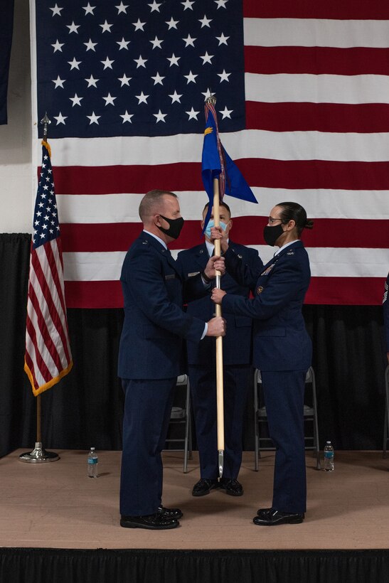 Brig. Gen. David May, Wisconsin's deputy adjutant general for Air, hands over the guide-on to Col. Leslie Zyzda-Martin