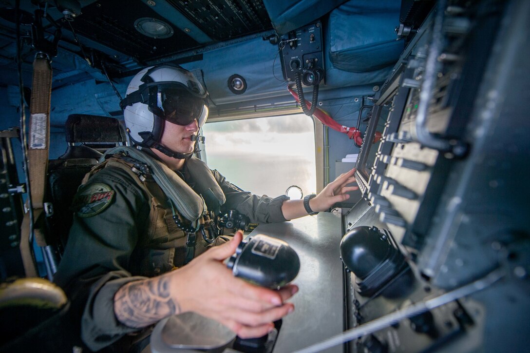 Navy helicopter tactical aircrewman 3rd class operates combat systems on MH-60R Sea Hawk assigned to “Wolf Pack” of Helicopter Maritime Strike Squadron 75, South China Sea, April 18, 2020 (U.S. Navy/Nicholas V. Huynh)