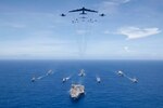 PHILIPPINE SEA (Sept. 17, 2018) USS Ronald Reagan (CVN 76) leads a formation of Carrier Strike Group 5 ships as U.S. Air Force B-52 Stratofortress aircraft and U.S. Navy F/A-18s pass overhead during Valiant Shield 2018. The biennial, U.S. only, field-training exercise focuses on integration of joint training among the U.S. Navy, Air Force and Marine Corps. This is the seventh exercise in the Valiant Shield series that began in 2006. (U.S. Navy photo by Mass Communication Specialist 3rd Class Erwin Miciano)