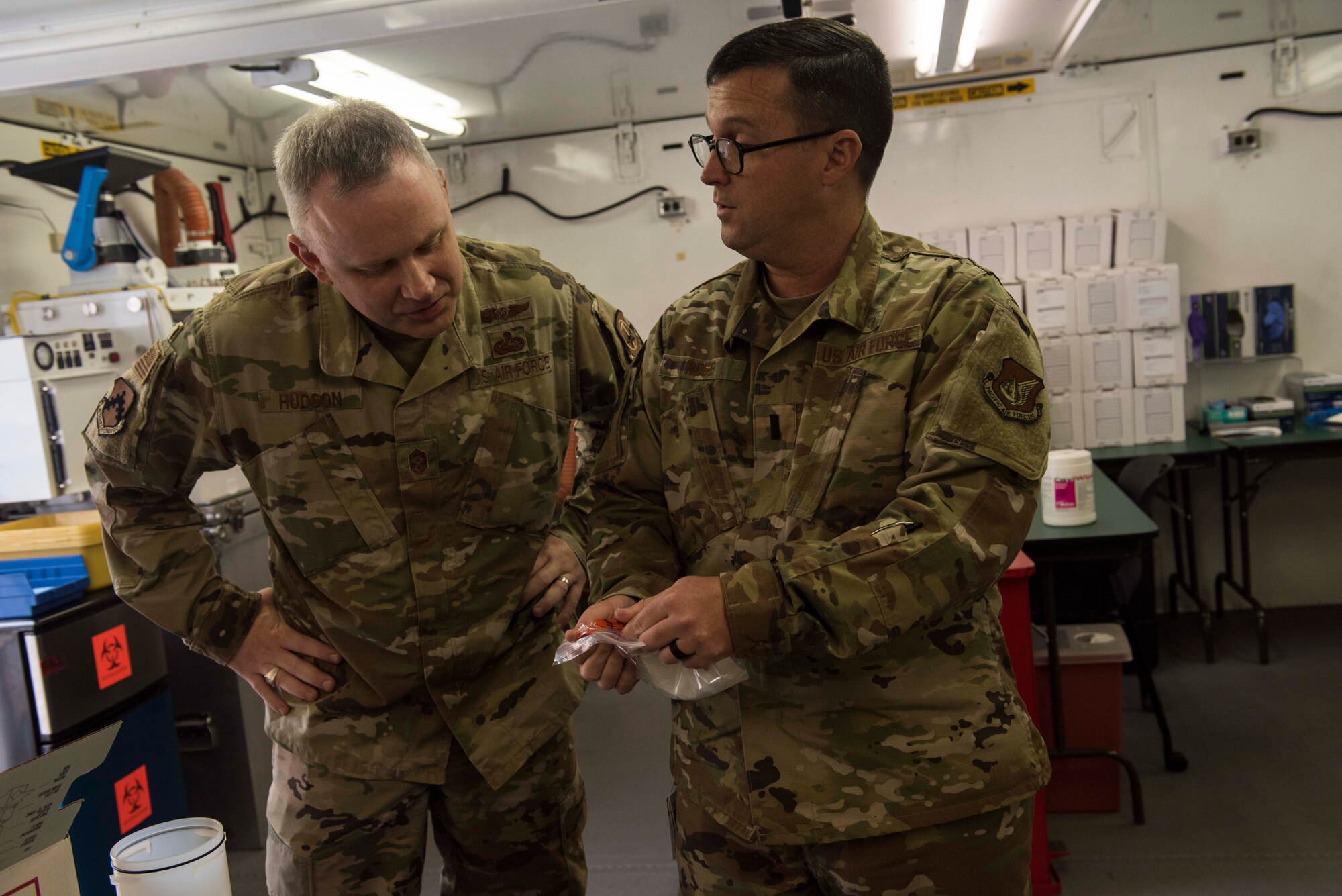 A photo of an Airman speaking to a commander.