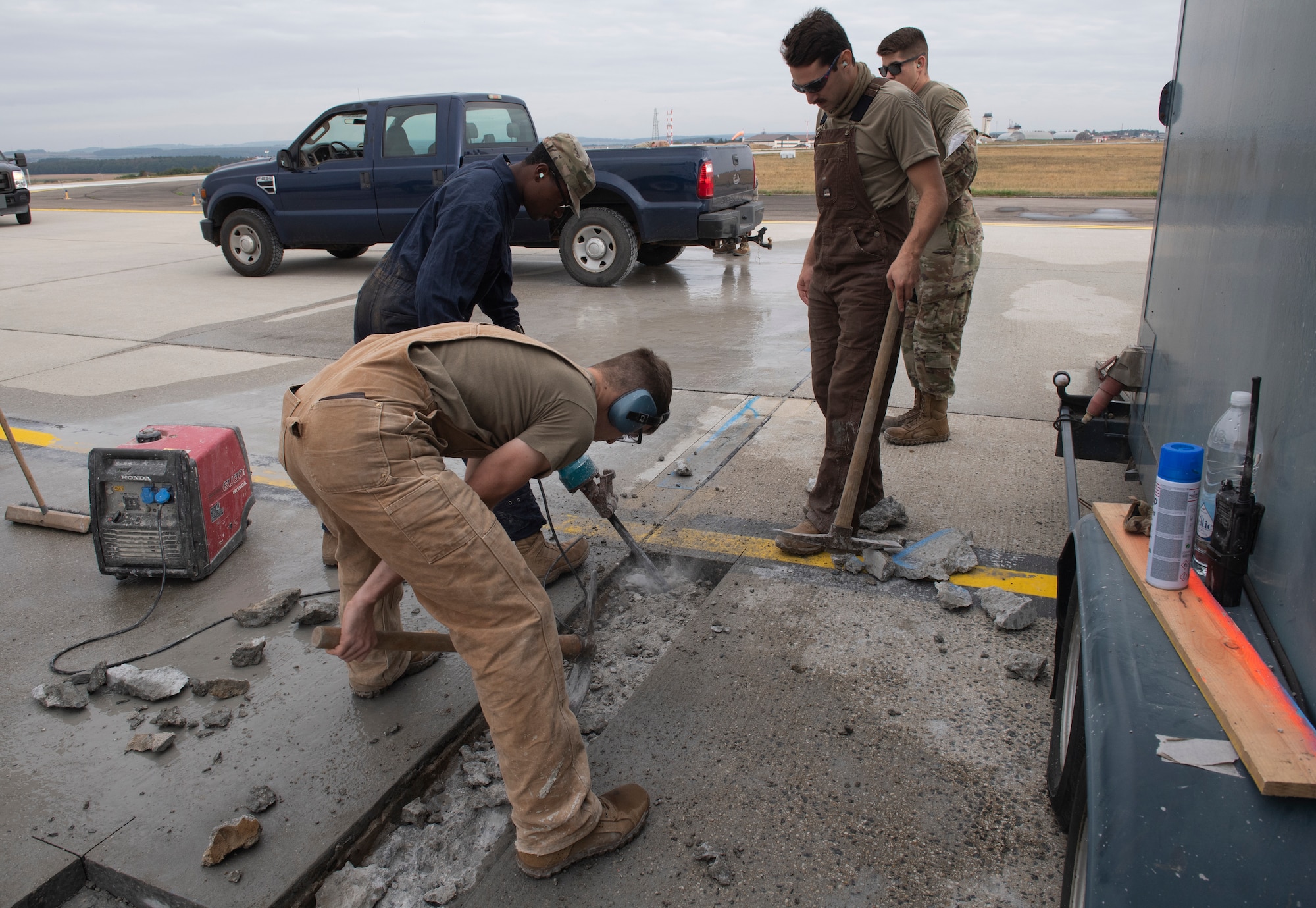U.S. Air Force Airmen from the 52nd Civil Engineer Squadron pavements and construction equipment shop use a jackhammer on concrete at Spangdahlem Air Base, Germany, Sept. 10, 2020. The Dirt Boyz fixed two large cracks on the flightline which prevented obstructions caused by foreign object debris. (U.S. Air Force photo by Airman 1st Class Alison Stewart)