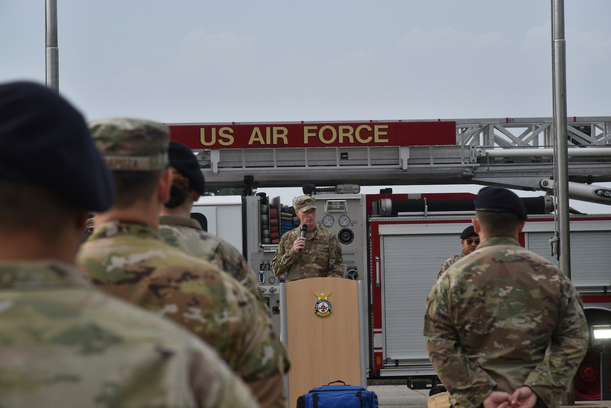 Col. Chris “Wolf” Hammond, 8th Fighter Wing commander, speaks with first responders during a 9/11 memorial service.