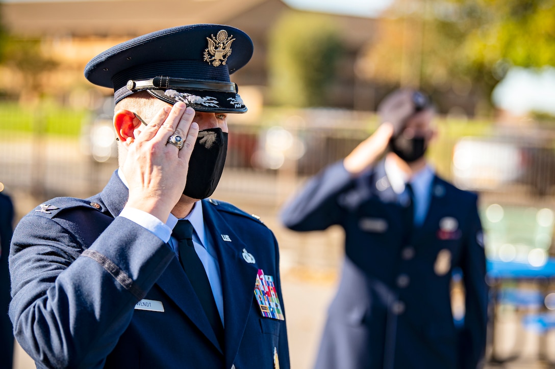 U.S. Air Force Col. Kurt. A. Wendt, left, 501st Combat Support Wing commander, salutes during a playing of the national anthem at RAF Alconbury, England, Sep. 9, 2020. Airmen from the 501st CSW along with cadets from the Alconbury High School JROTC participated in a 9/11 remembrance ceremony to honor those who lost their lives during the September 11th terrorist attacks. (U.S. Air Force photo by Senior Airman Eugene Oliver)