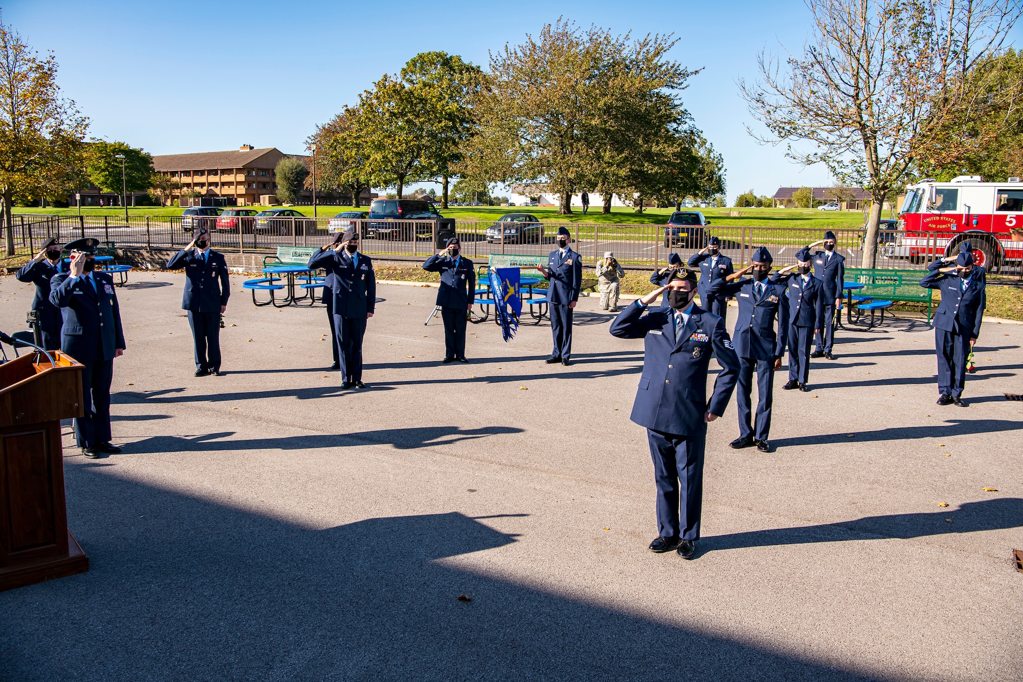 Cadets from the Alconbury Highschool JROTC along with Airmen from the 501st Combat Support Wing, salute during a playing of the national anthem at RAF Alconbury, England, Sep. 9, 2020. Airmen and Cadets participated in the ceremony to honor those who lost their lives during the September 11th terrorist attacks. (U.S. Air Force photo by Senior Airman Eugene Oliver)