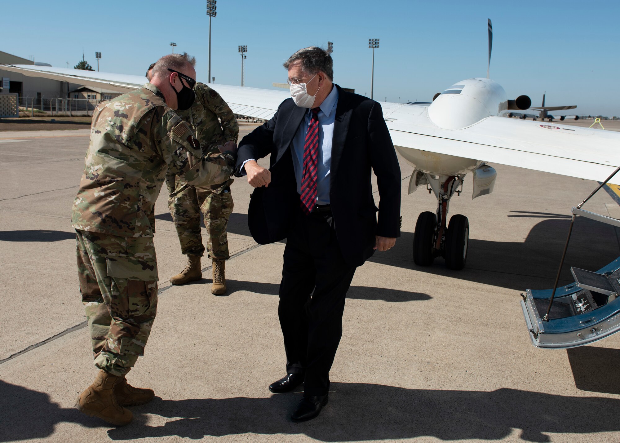 U.S. Air Force Col. John Creel, 39th Air Base Wing commander, greets U.S. Ambassador to Turkey David Satterfield with an elbow bump on the base's flightline.
