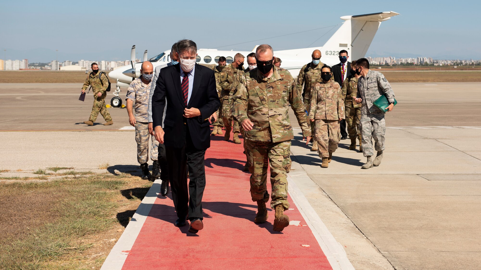 Col. John Creel, 39th Air Base Wing commander, and U.S. Ambassador to Turkey David Satterfield walk down the flight line "red carpet" with retinue in-tow behind them.