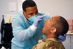 U.S. Army Sgt. Carlos Mayfield, combat medic, 557th MCAS, 30th Medical Brigade, performs a nose swab test on Lt. Col. Jerry Wood Jr., squadron commander, assigned to the 4th Squadron, 2nd Cavalry Regiment, during the Noble Partner 20 exercise at the Vaziani Training Area, Georgia, Sept. 10, 2020.