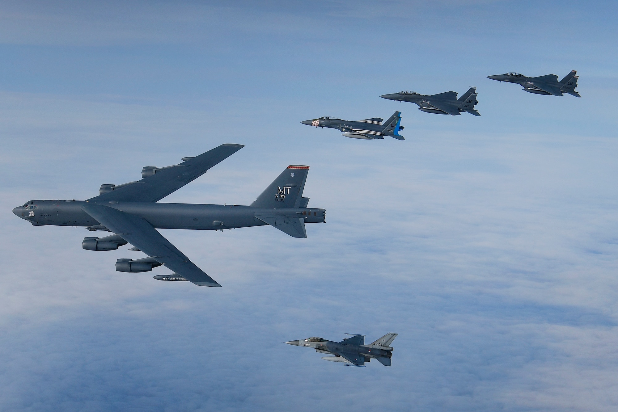 A U.S. Air Force B-52H Stratofortress leads a formation of U.S. F-15C Eagles, F-15E Strike Eagles and Royal Netherlands Air Force F-16's over the North Sea during exercise Point Blank 20-04. Point Blank is a recurring, low-cost exercise initiative designed to increase tactical proficiency of U.S., Ministry of Defence, and other NATO forces. (U.S. Air Force photo/ Master Sgt. Matthew Plew)