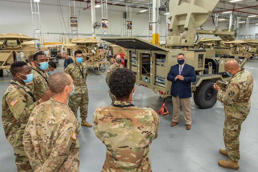 Anthony Brandi, Chief of Tobyhanna's SATCOM System Division, briefs Soldiers on the Satellite Transportable Terminal.