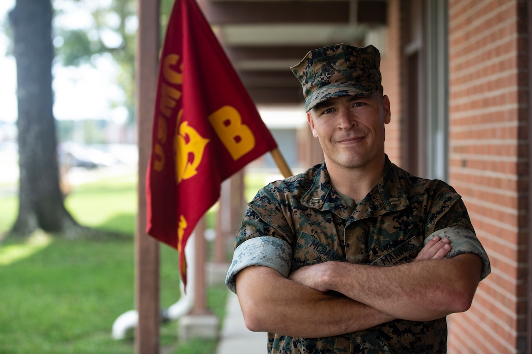 U.S. Marine Corps Capt. Brenden D. McDaniel, commanding officer, Bravo Company, Headquarters and Support Battalion, Marine Corps Installations East-Marine Corps Base Camp Lejeune, poses in front of the Bravo Company barracks on Sept. 3, 2020. On Sept. 11, 2001, McDaniel was a freshman at Concordia College, although he had no plans to join the military at the time, he did see his father, who was active duty Air Force, deploy multiple times because of the terrorist attacks that day. This year marks the 19th anniversary of Patriots Day, which honors the nearly 3,000 American citizens, civil servants, and first responders whose lives were taken as a result of the terrorist attacks that took place on Sept. 11, 2001. (U.S. Marine Corps Photo by Lance Cpl. Isaiah Gomez)