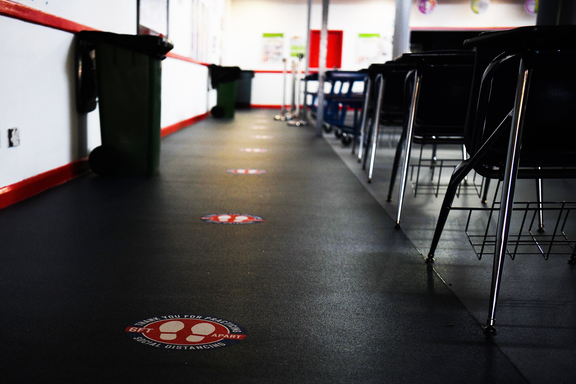 Social distancing signs mark two-meter spacing at the Lakenheath High School at Royal Air Force Lakenheath, England, Aug. 12, 2020. The 48th Civil Engineer Squadron Airmen overhauled the tri-base schools, focusing on COVID-safe measures and infrastructure upgrades to support school operations, serving over 2000 students. (U. S. Air Force photo by Senior Airman Shanice Williams-Jones)