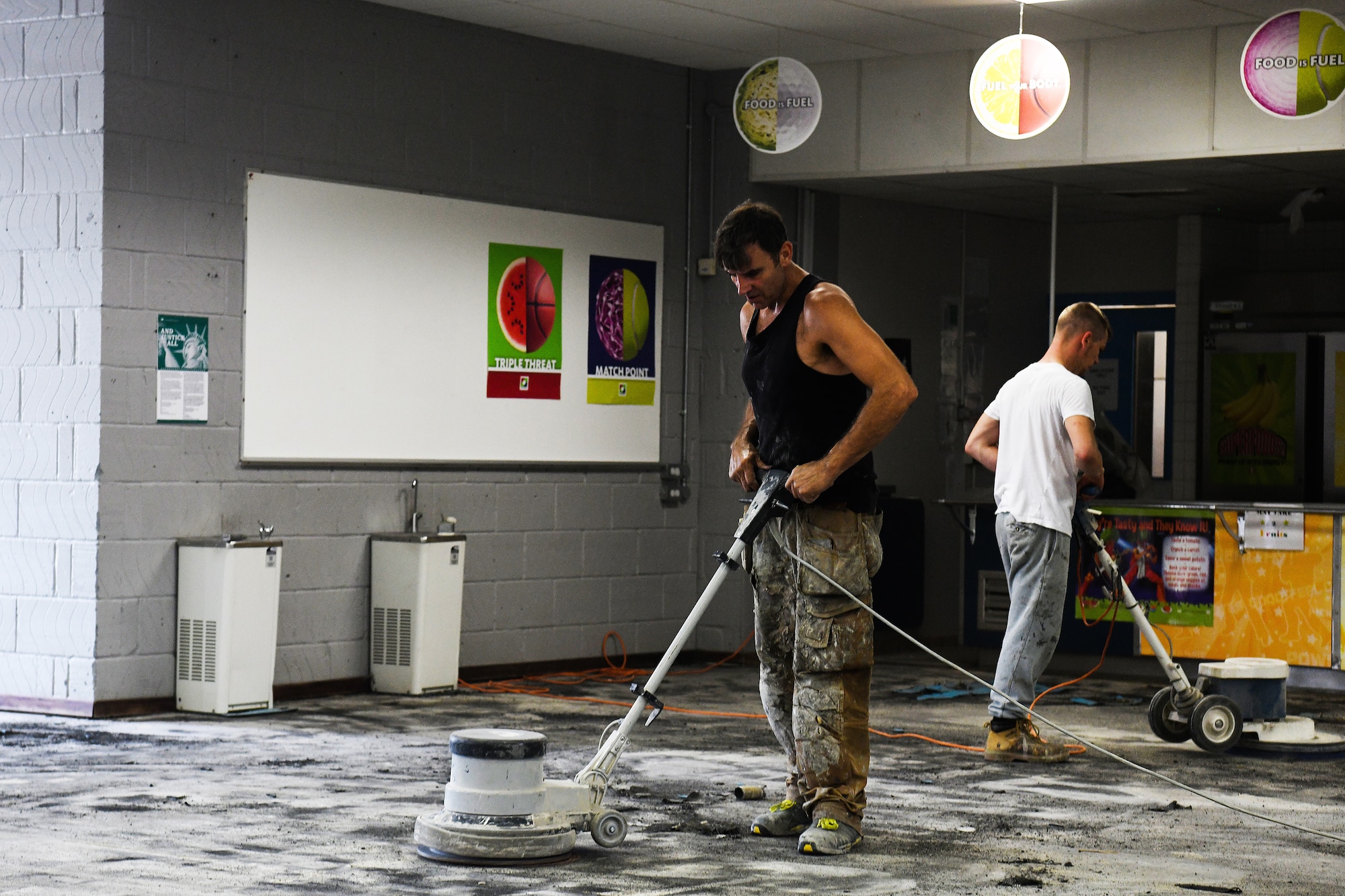 Base contractors strip the flooring from the Lakenheath Elementary School cafeteria at Royal Air Force Lakenheath, England, Aug. 11, 2020. The 48th Civil Engineer Squadron Airmen and base contractors overhauled the tri-base schools focusing on COVID-safe infrastructure upgrades to support school operations, serving over 2,000 students. (U. S. Air Force photo by Senior Airman Shanice Williams-Jones)