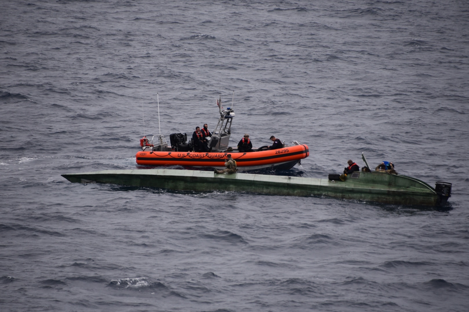 Coast Guard Cutter Bertholf (WMSL-750) crewmembers inspect a low-profile semi-submersible in international waters of the Eastern Pacific Ocean Aug. 14, 2020.
