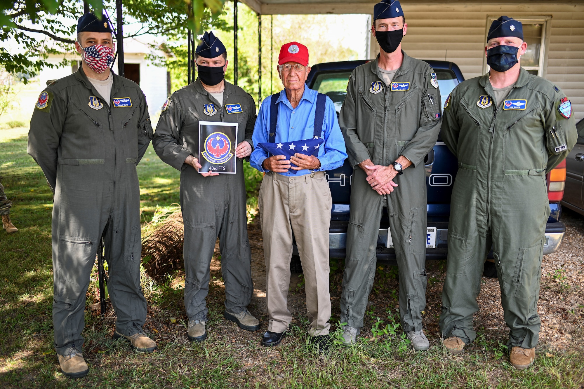 Bradford Freeman, assigned to ‘Easy’ Company, 2nd Battalion of the 506th Parachute Infantry Regiment of the 101st Airborne Division, stand with members from the 43rd Flying Training Squadron at Freeman’s residency Sept. 3, 2020 in Miss. The 43rd FTS flew an American Flag in each trainer airframe over Columbus Air Force Base, Miss. and raised the flag outside Freeman’s House in honor of his service and sacrifice to the U.S. (U.S. Air Force photo by Senior Airman Keith Holcomb)