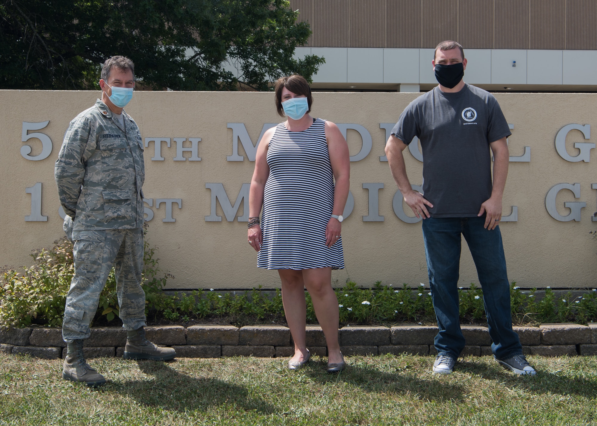 U.S. Air Force Maj. Sean FitzPatrick, a Family Advocacy Officer, left, Bethany Burkhart, a Domestic Abuse Victim Advocate, center, and Cory Watson, a family advocacy intervention specialist, right ,with the 509th Medical Group Family Advocacy Program stand for a photo on August 28, 2020 in front of the 509th MDG Clinic at Whiteman Air Force Base, Missouri. The overall military Family Advocacy Program has the primary goals of preventing abuse, encouraging early identification and prompt reporting, promoting victim safety and empowerment, and providing appropriate treatment for affected service members and their families. (U.S. Air Force photo by Airman 1st Class Parker J. McCauley)