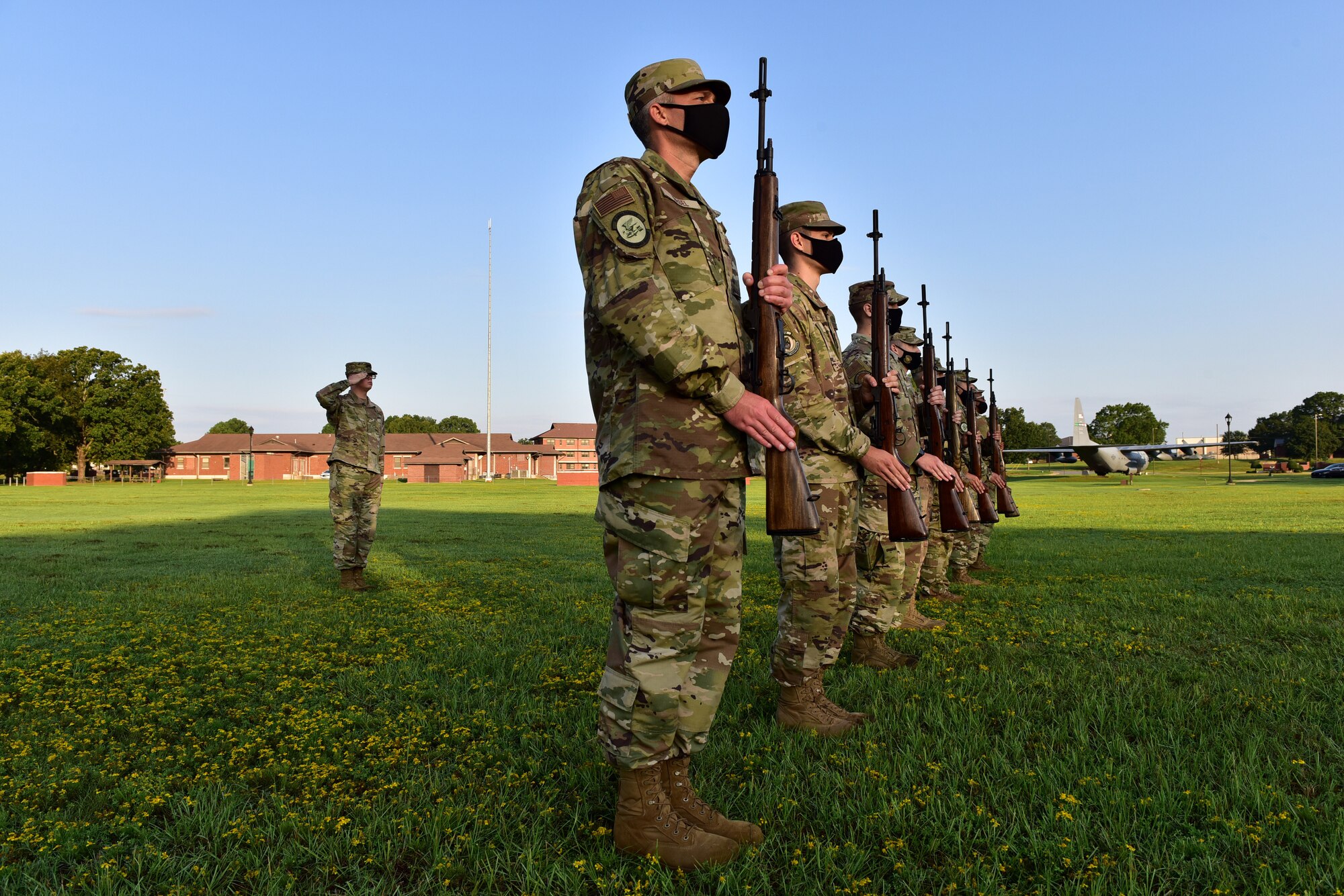 Airmen stand ready to perform a 21-gun salute