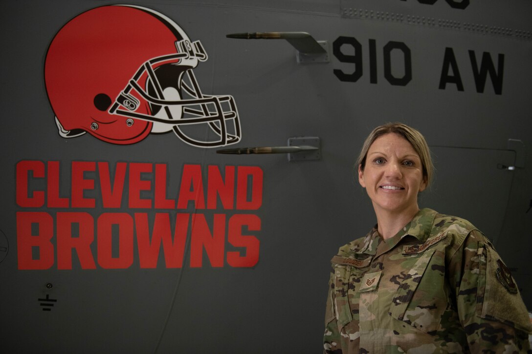 Staff Sgt. Juliet Louden, the NCOIC of community engagement assigned to the 910th Airlift Wing public affairs office, poses next to a C-130H Hercules with a Cleveland Browns logo as its nose art, Aug. 1, 2020, at Youngstown Air Reserve Station.