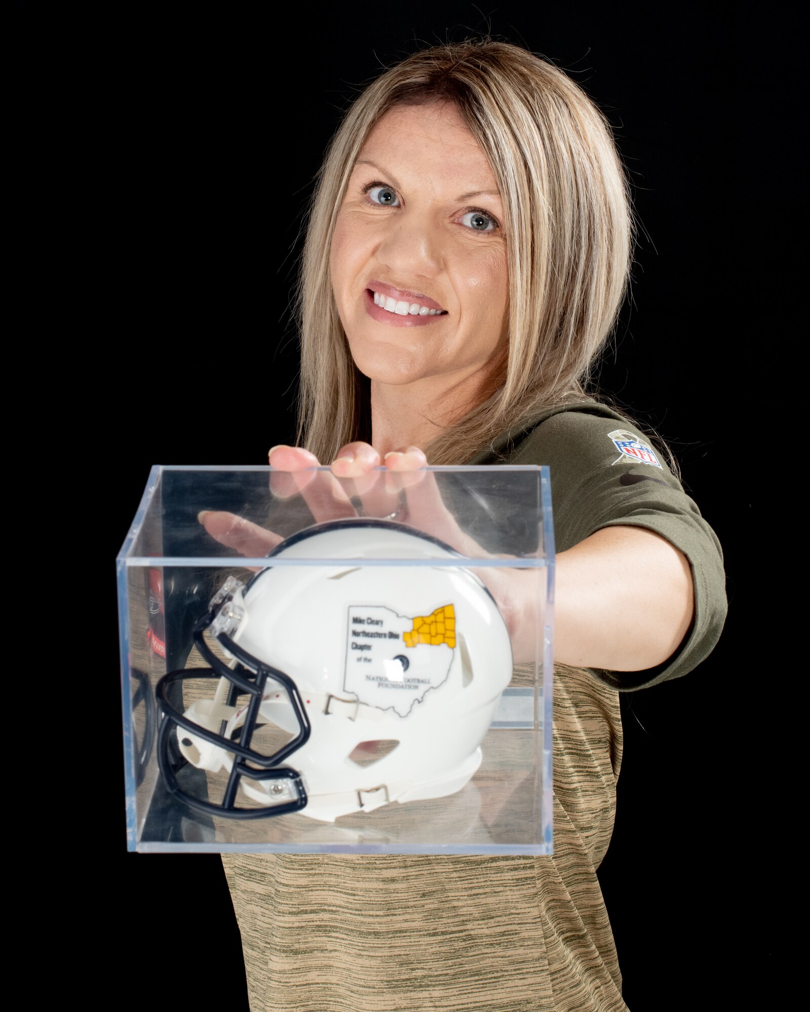 Staff Sgt. Juliet Louden, the NCOIC of community engagement assigned to the 910th Airlift Wing public affairs office, holds a football, July 1, 2020, awarded to her son, Cullen Martin, by the National Football Foundation.