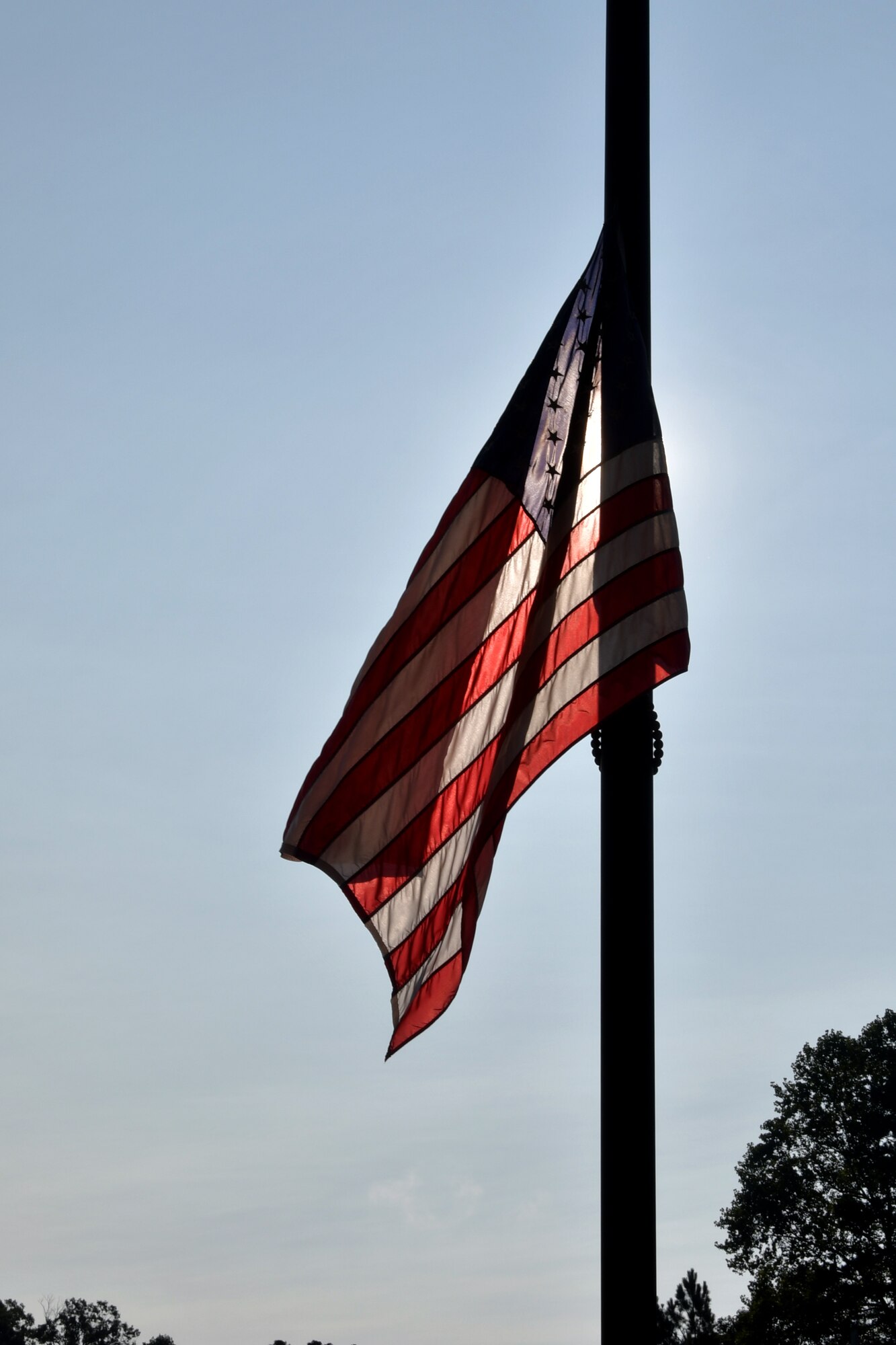A U.S. flag flies at half-mast during a 9/11 Remembrance Ceremony at the POW/MIA Memorial at Dobbins Air Reserve Base, Ga. The ceremony included a moment of silence, command commentaries and an honor guard presentation. (U.S. Air Force photo by Senior Airman Shelby Thurman)