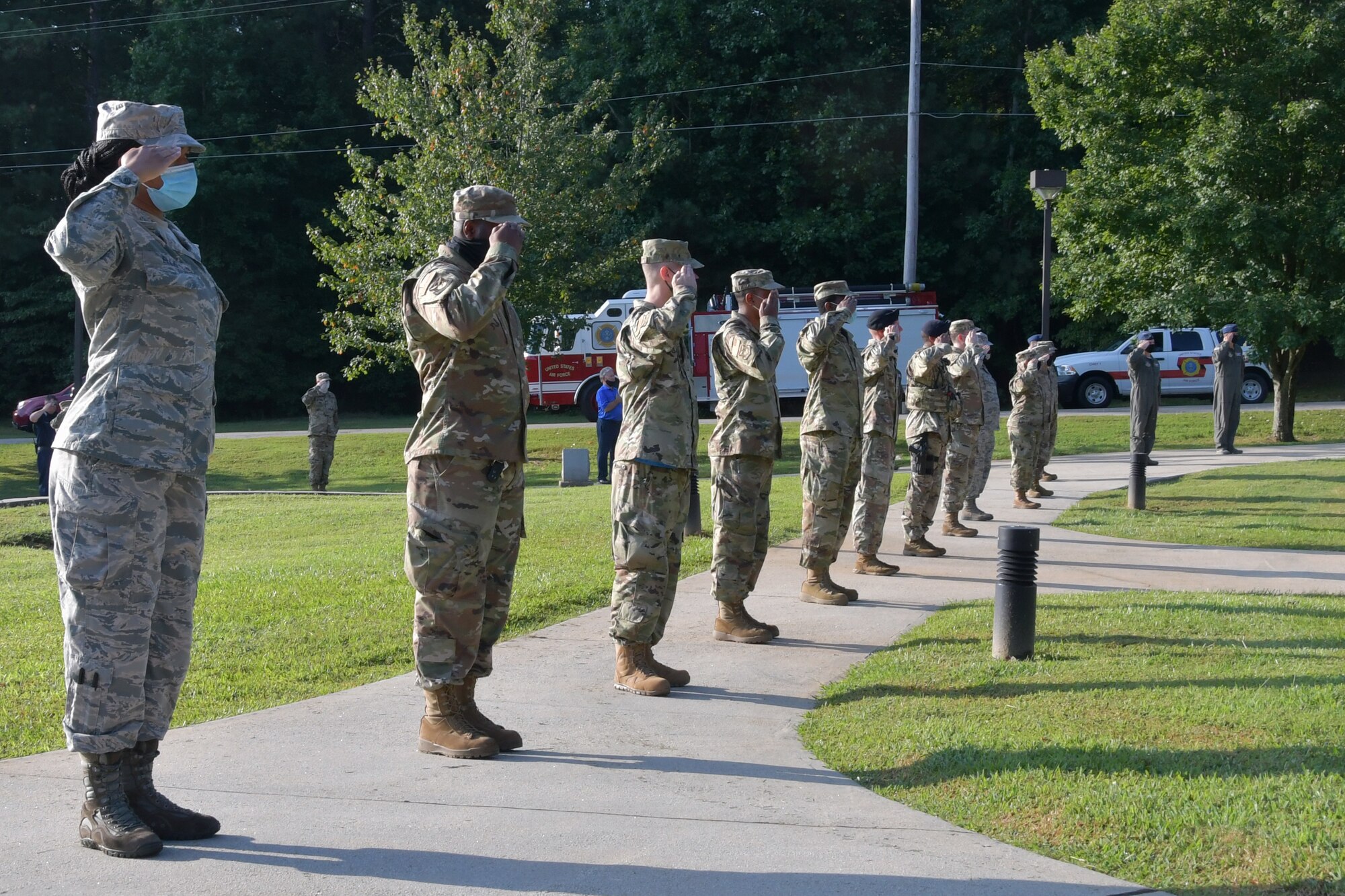 Airmen with the 94th Airlift Wing salute during a 9/11 Remembrance Ceremony at the POW/MIA Memorial at Dobbins Air Reserve Base, Ga. The ceremony included a moment of silence, command commentaries and an honor guard presentation. (U.S. Air Force photo by Senior Airman Shelby Thurman)