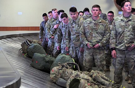 Alaska Army National Guard Soldiers assigned to 1st Battalion, 297th Infantry Regiment eagerly wait for their luggage to arrive after flying into Ted Stevens Anchorage International Airport Apr. 4, 2020. The Soldiers returned from a 9 month deployment to Kosovo for a NATO peacekeeping mission. (U.S. Army National Guard photo by Sgt. Seth LaCount/Released)
