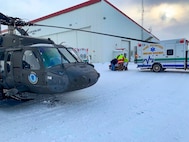 An Alaska Army National Guard UH-60 Black Hawk helicopter aircrew performed a search and rescue mission for three Iditarod mushers about 25 miles east of Nome, March 20, 2020. The mushers and their dogs went through Bering Sea flood waters on the race trail and were wet and freezing. The aircrew transported two firefighter emergency medical technicians and Iditarod dog handlers to assist. The mushers were flown to Nome and transported to a local hospital. A local search and rescue team helped race dog handlers care for the sled team and returned them to Nome. (Courtesy photo)
