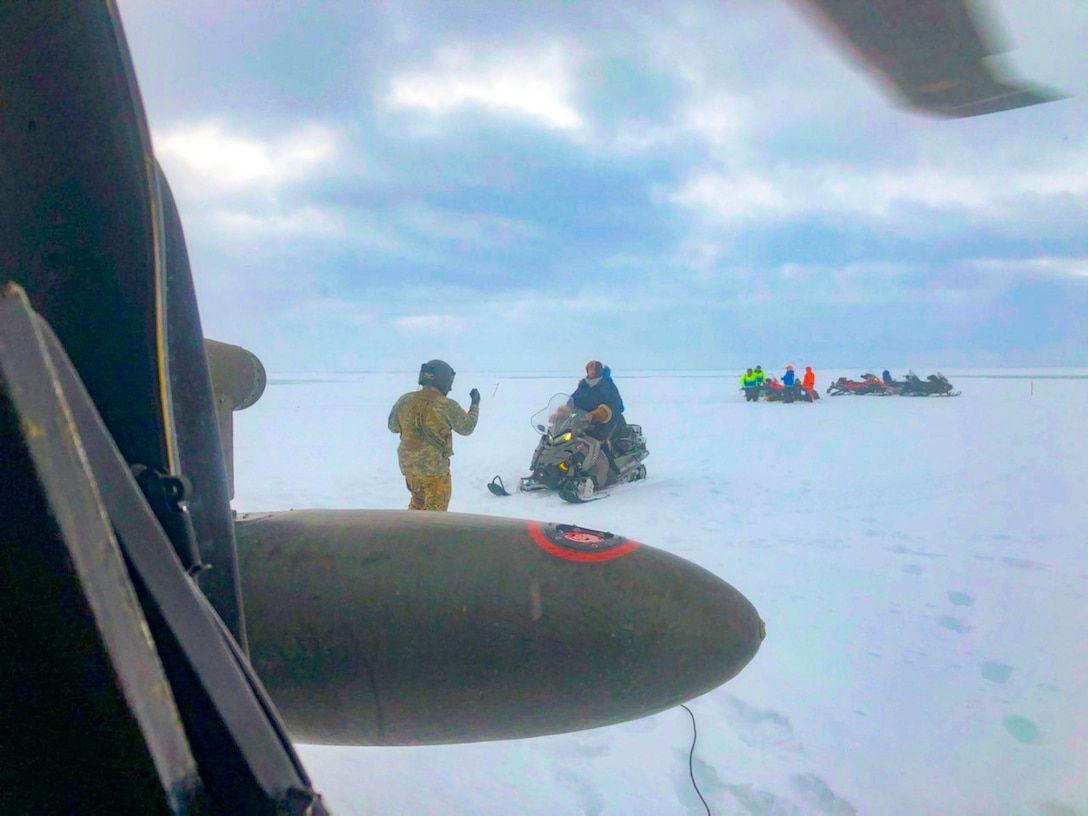 An Alaska Army National Guard UH-60 Black Hawk helicopter aircrew performed a search and rescue mission for three Iditarod mushers about 25 miles east of Nome, March 20, 2020. The mushers and their dogs went through Bering Sea flood waters on the race trail and were wet and freezing. The aircrew transported two firefighter emergency medical technicians and Iditarod dog handlers to assist. The mushers were flown to Nome and transported to a local hospital. A local search and rescue team helped race dog handlers care for the sled team and returned them to Nome. (Courtesy photo)