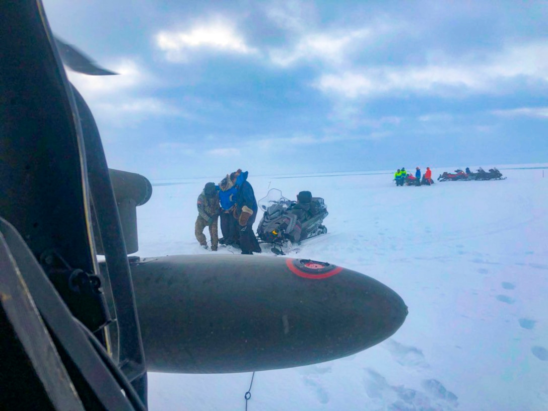 An Alaska Army National Guard UH-60 Black Hawk helicopter aircrew performed a search and rescue mission for three Iditarod mushers about 25 miles east of Nome, March 20, 2020. The mushers and their dogs went through Bering Sea flood waters on the race trail and were wet and freezing. The aircrew transported two firefighter emergency medical technicians and Iditarod dog handlers to assist. The mushers were flown to Nome and transported to a local hospital. A local search and rescue team helped race dog handlers care for the sled team and returned them to Nome. (Courtesy photo)