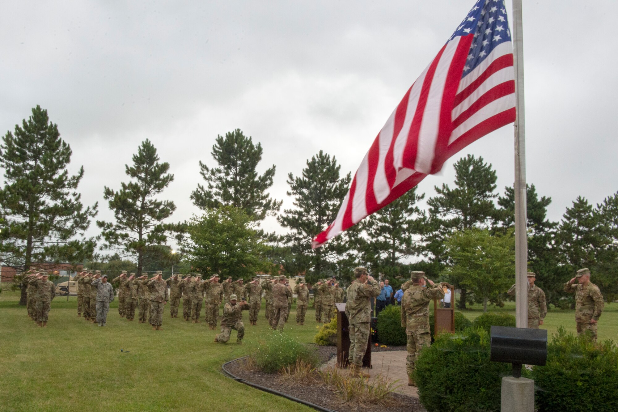 Men and Women from the 434th Air Refuling Wing salute the flag here Sept. 11, 2020, during morning reverly to pay tribute to those lives that were lost on 9/11. The ceremony included a moment of silence and prayer.